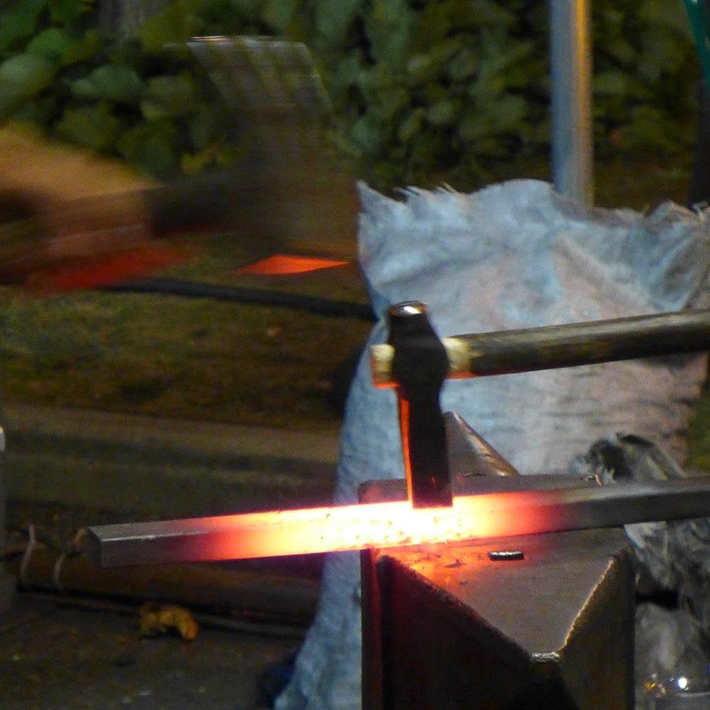Schmiedehammer saust auf glühendes Eisenstück auf Amboss runter. Illustrierend zum Artikel: Blogparaden in der Kultur